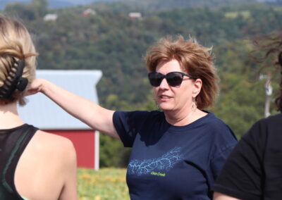 Nancy Wedwick teaches a student group about agriculture conservation on a ridge overlooking Coon Valley. During the 1930s, Coon Valley residents collaborated with state and federal partners to significantly reduce flooding and erosion in this watershed as part of the nation's first watershed conservation project. Photo: Sydney Widell